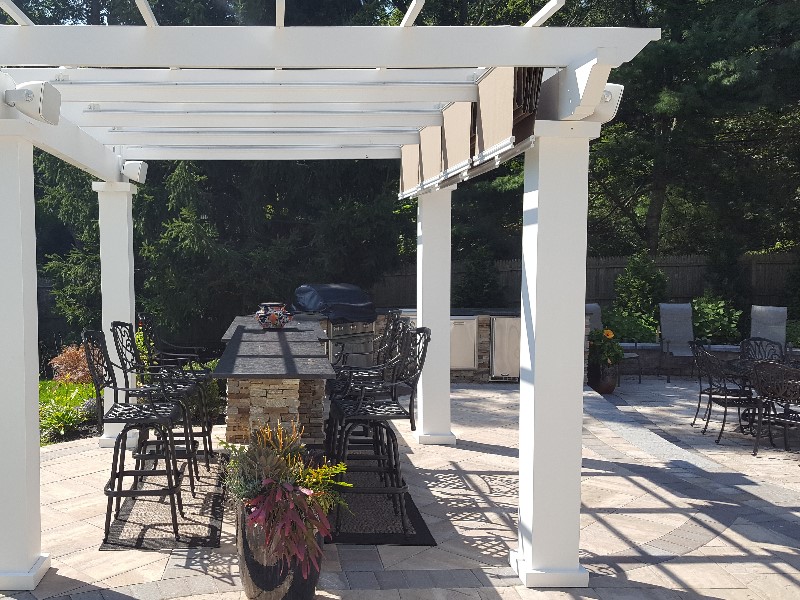 patio with slide shade pergola and bar island